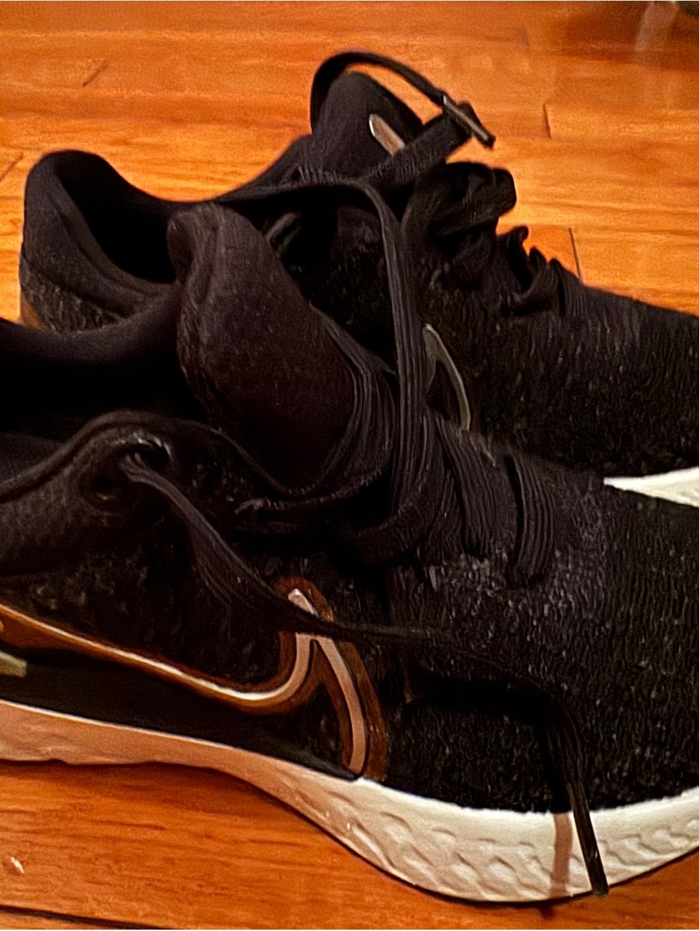 Nike Women's Black Athletic Shoes with White Sole and Gold Swoosh